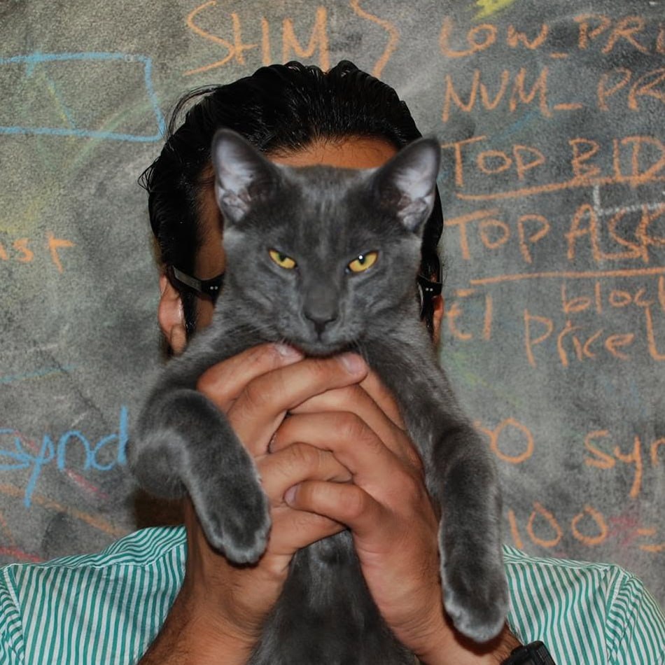 Fidel Catstro blocking Baiju Bhatt's face in front of the chalkboard